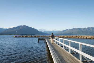 Scenic view of lake against clear blue sky