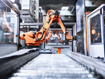 Robotic arm over conveyor belt in factory