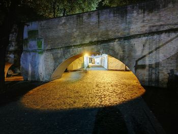 Illuminated bridge over water at night