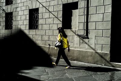 Full length of woman standing in front of building