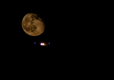 Low angle view of moon against clear sky at night