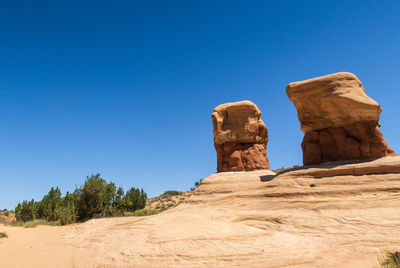 Rock formations against clear blue sky