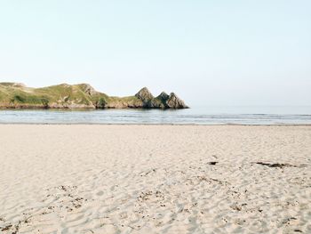 Scenic view of beach against clear sky