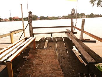 Pier amidst river against clear sky