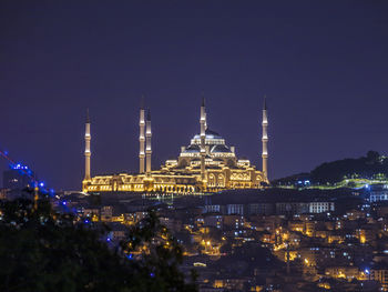 Illuminated buildings in city at night