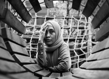 Low angle view of young woman sitting on steps