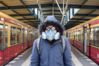 Portrait of man with mask  at railroad station