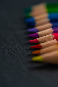 Close-up of multi colored pencils on table