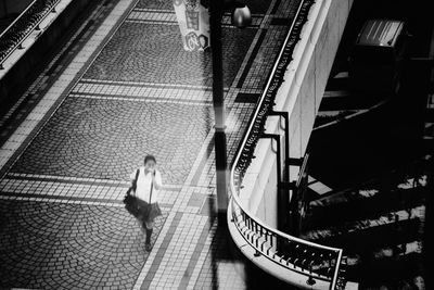 High angle view of woman walking on bridge