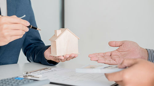 Midsection of woman holding paper with text on table