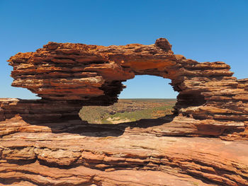 Rock formation against clear blue sky