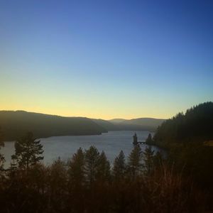 Scenic view of lake and mountains against clear sky