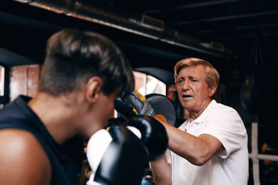 Coach teaching boxing to student