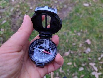 Close-up of hand holding compass