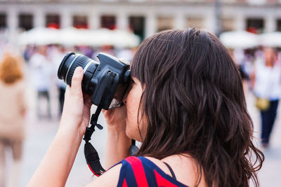 Rear view of woman photographing