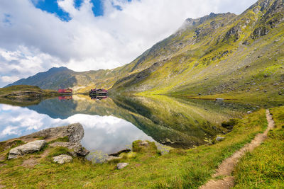 Scenic view of transylvanian alps mirrored to high altitude balea lake in romania 