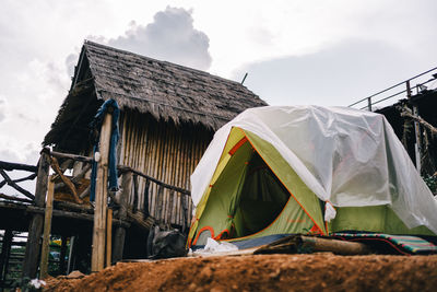 Low angle view of tent on roof of building against sky