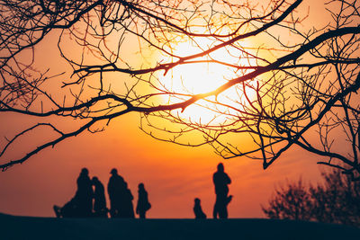 Silhouette people against sky during sunset