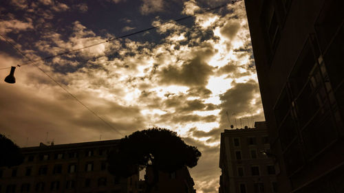 Low angle view of silhouette buildings against sky