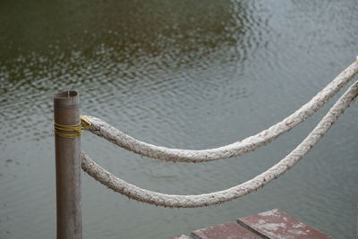 High angle view of rope tied to bollard