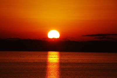 Scenic view of sea against romantic sky at sunset