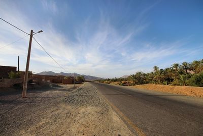 Road passing through landscape against sky