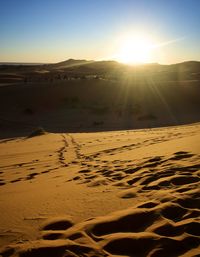 Scenic view of desert against sky during sunset