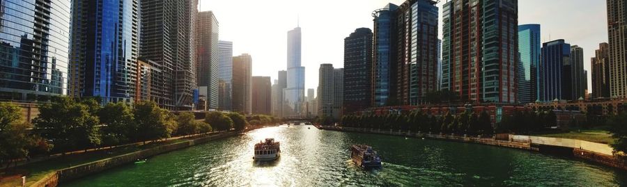 River amidst buildings against sky in city