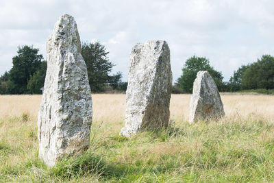 Stone structure on field against sky