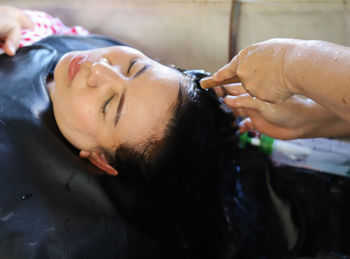 Close-up portrait of woman lying on wet floor