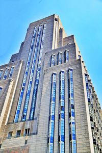 Low angle view of modern building against clear blue sky