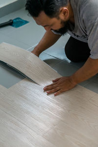 Man cutting hardwood floor