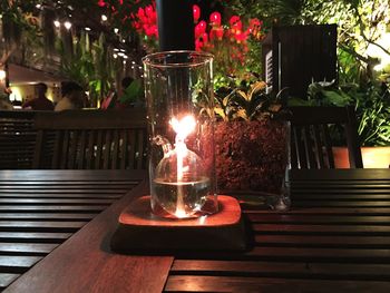 Close-up of illuminated candles on table