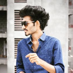 Young man wearing sunglasses standing outdoors