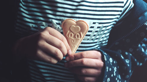 Midsection of girl holding ice cream cone