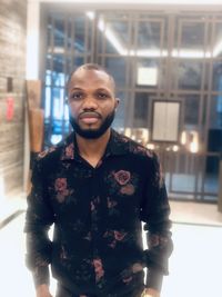 Portrait of young man standing at home