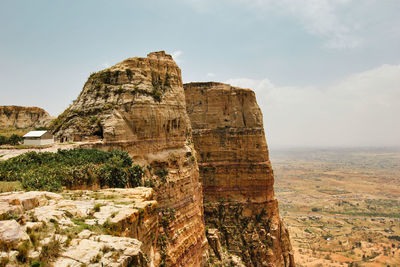Rock formations on landscape against sky
