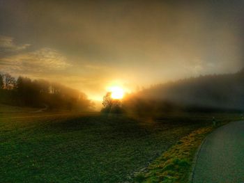 Scenic view of field against sky during sunset