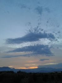 Low angle view of silhouette mountain against dramatic sky