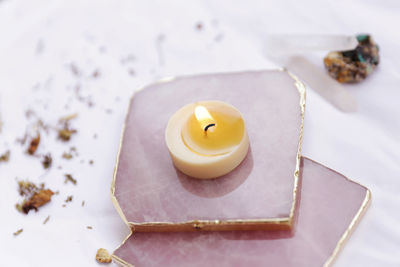 Close-up of lit candle on table