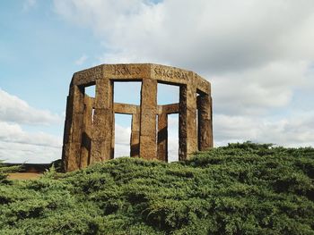 Old ruin on field against sky