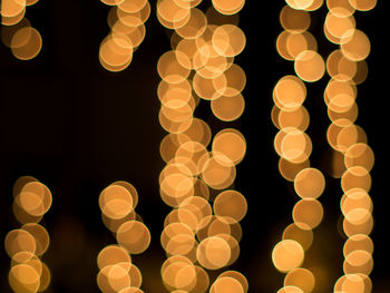 Illuminated lights against sky at night