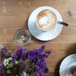 Directly above shot of coffee cup on wooden table