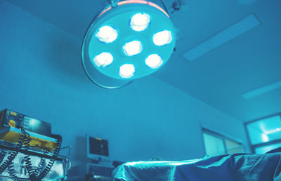 Low angle view of illuminated pendant light at home