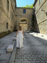 Rear view of woman standing on street