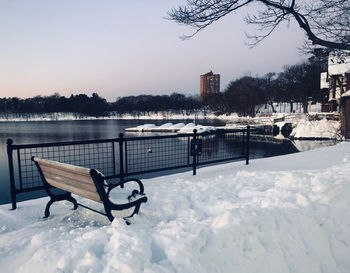 Empty benches on snow covered park during winter