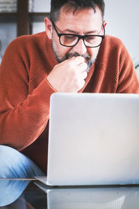 Young man using laptop at home