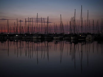 Sailboats in marina at sunset