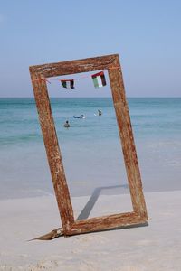 Lifeguard hut on beach against clear sky
