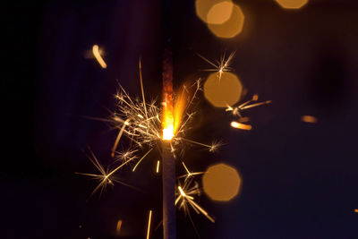 Close-up of illuminated sparkler at night